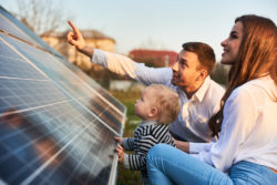 Family observing solar powered panels