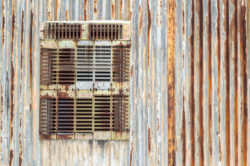 Corrugated ceiling and wall for a rustic, farm style bathroom