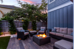 A wooden deck alternative built outside with a fire pit